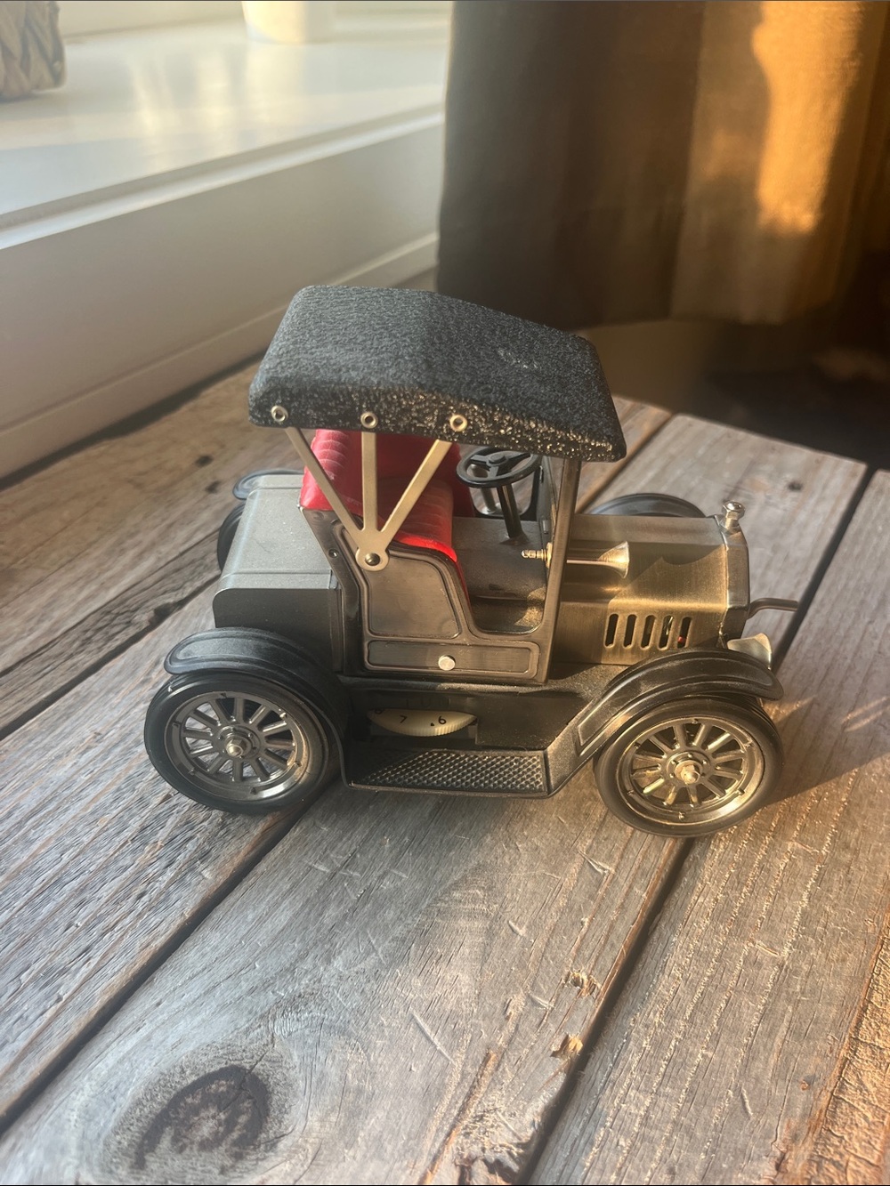Vintage-style Metal Toy Car with Black Canopy and Red Seat